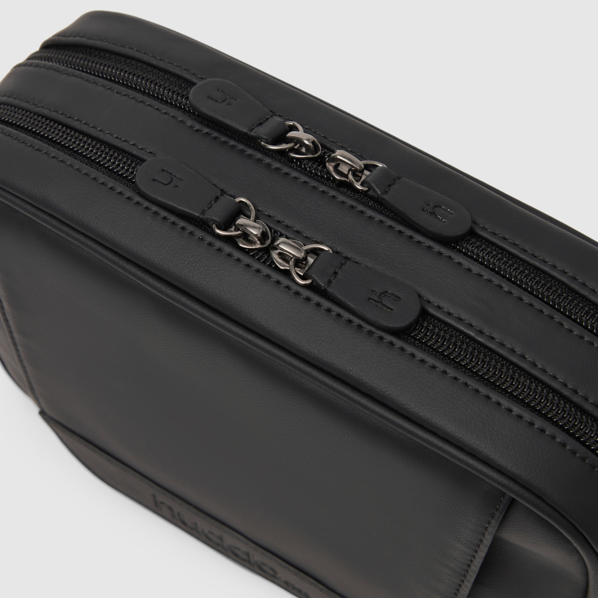 black pineapple leather crossbody baby bag with wipes dispenser arial view of zipper hardware