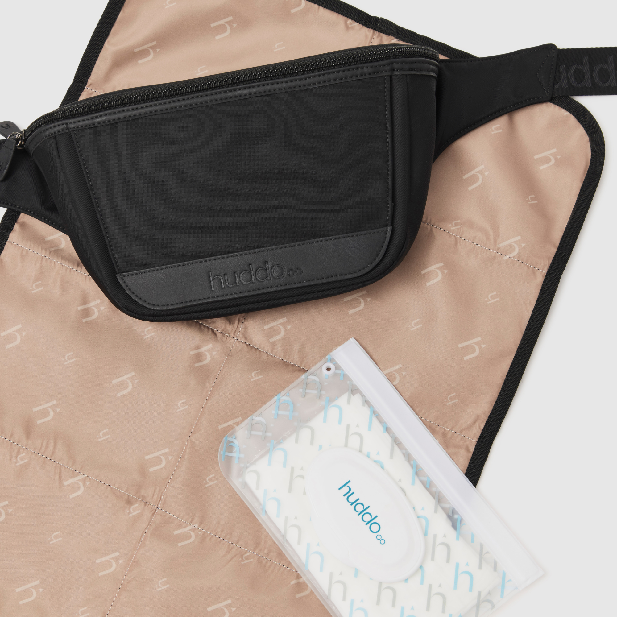 nappy buddy belt bag shown with wipes dispenser with refillable wipes case, reusable change mat and refillable wipes case included with bag