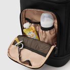 front insulated pocket on huddoco anywhere baby backpack filled with large baby bottle and yoghurt pouch - with dummy on key leash