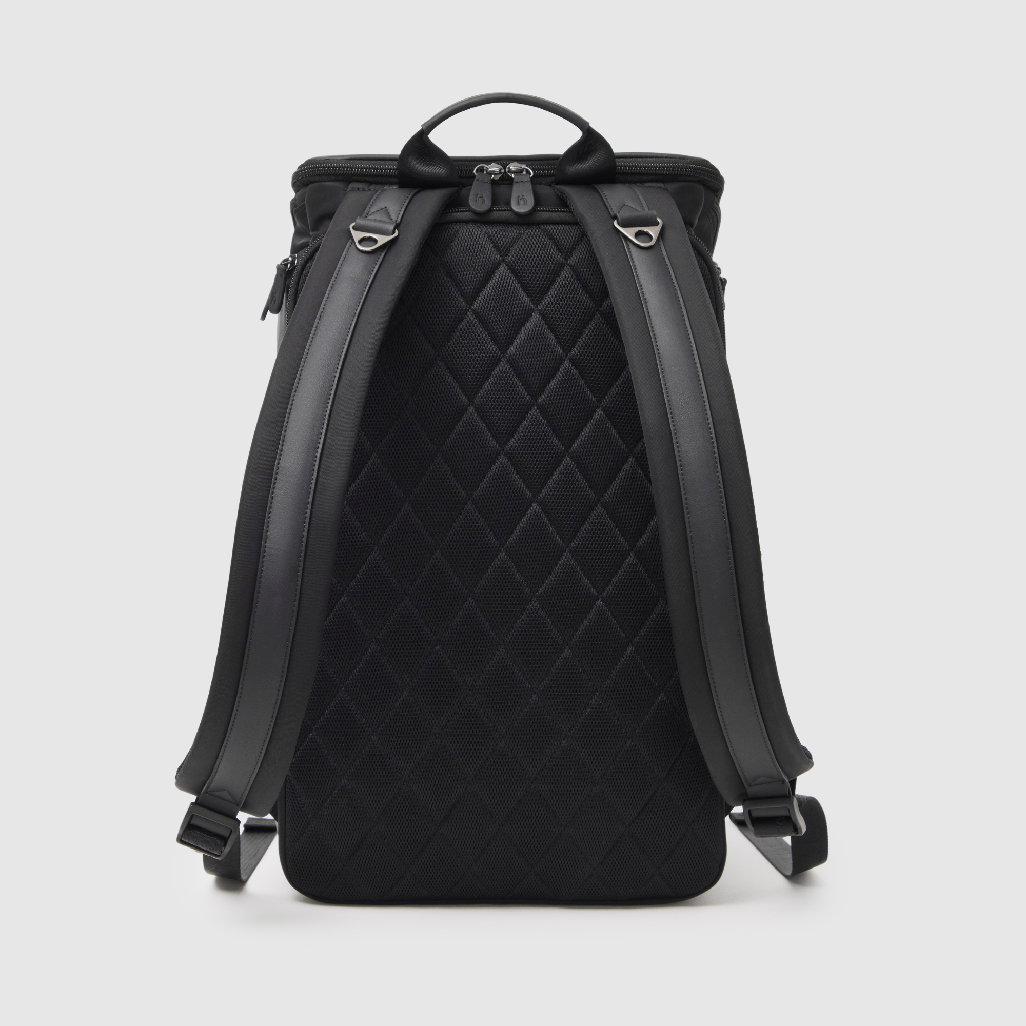 huddoco anywhere baby backpack with pineapple leather and recycled nylon - back corner angle showing airmesh back panel, shoulder straps with leather feature and grab handle reinforced with leather