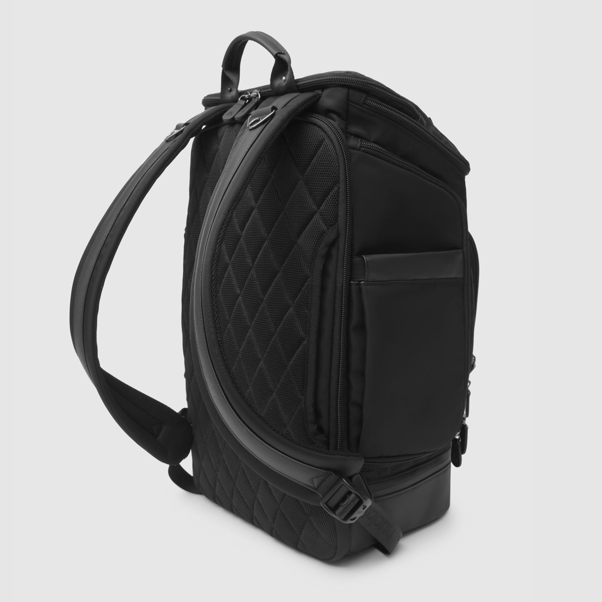 huddoco anywhere baby backpack with pineapple leather and recycled nylon - back corner angle showing airmesh back panel, shoulder straps with leather feature and luggage passthrough for use on suitcase