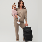 mother with toddler holding huddoco anywhere baby backpack