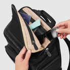 person putting parent essential items in parent pocket of anywhere baby backpack