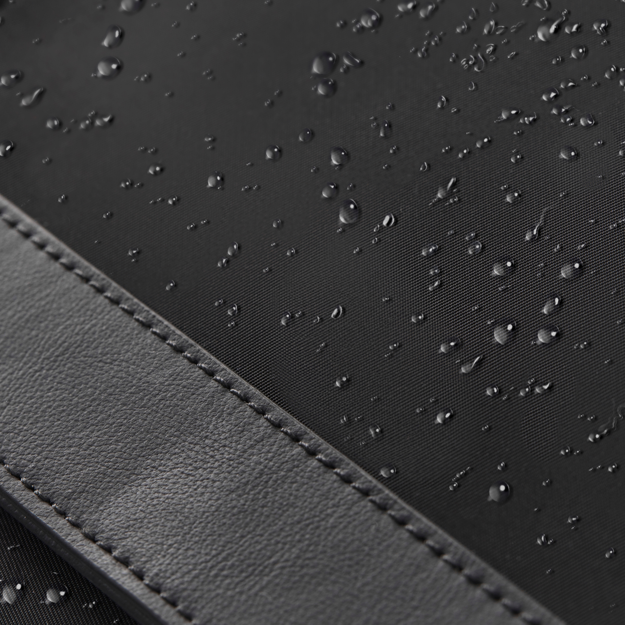 close up of anywhere baby backpack waterproof recycled nylon featuring pineapple leather accent